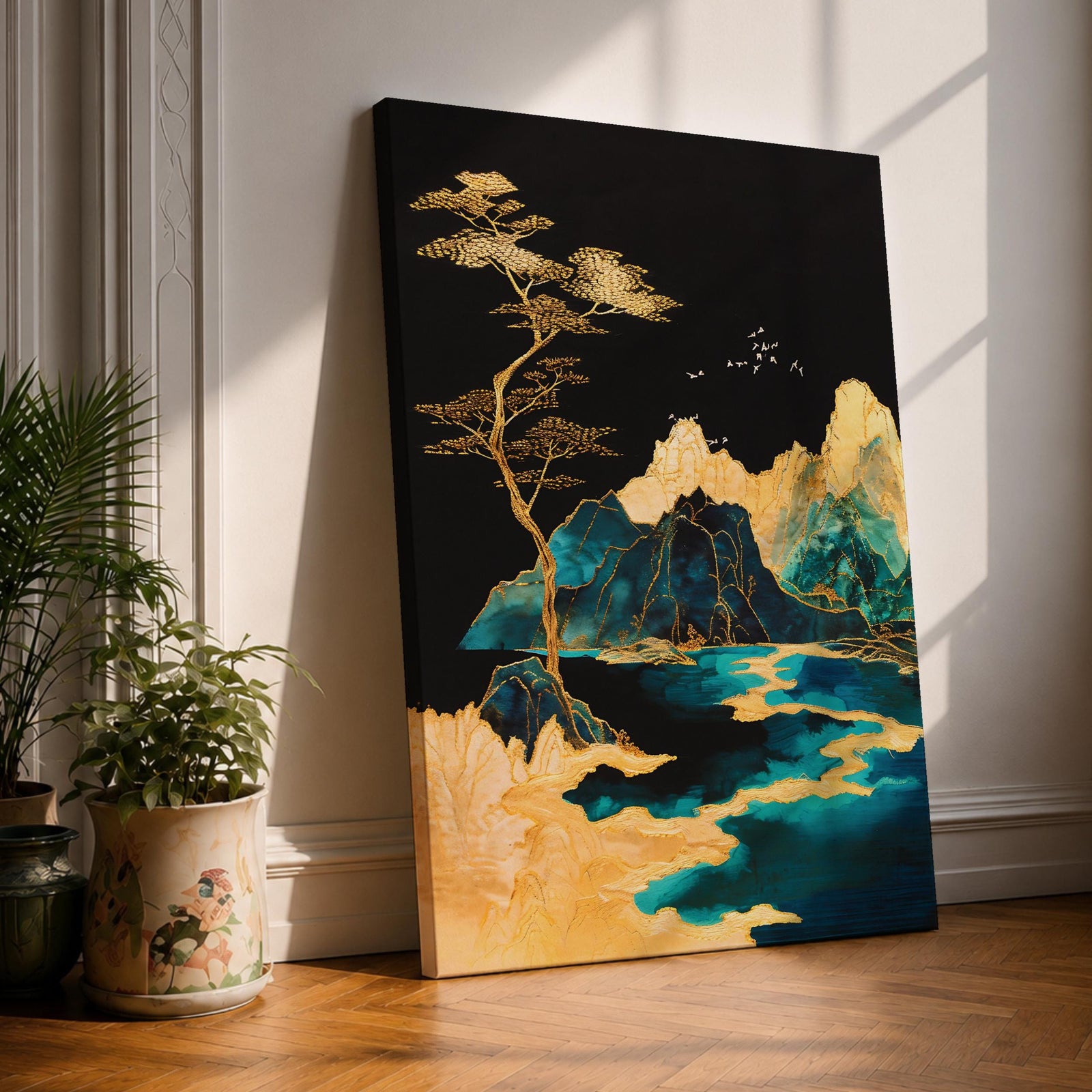 A framed canvas artwork depicting a mountain landscape with abstract golden and teal elements. The composition features stylized mountains, a flowing river, and a tall tree with birds flying above, rendered in an abstract style with rich gold and blue tones against a dark background.