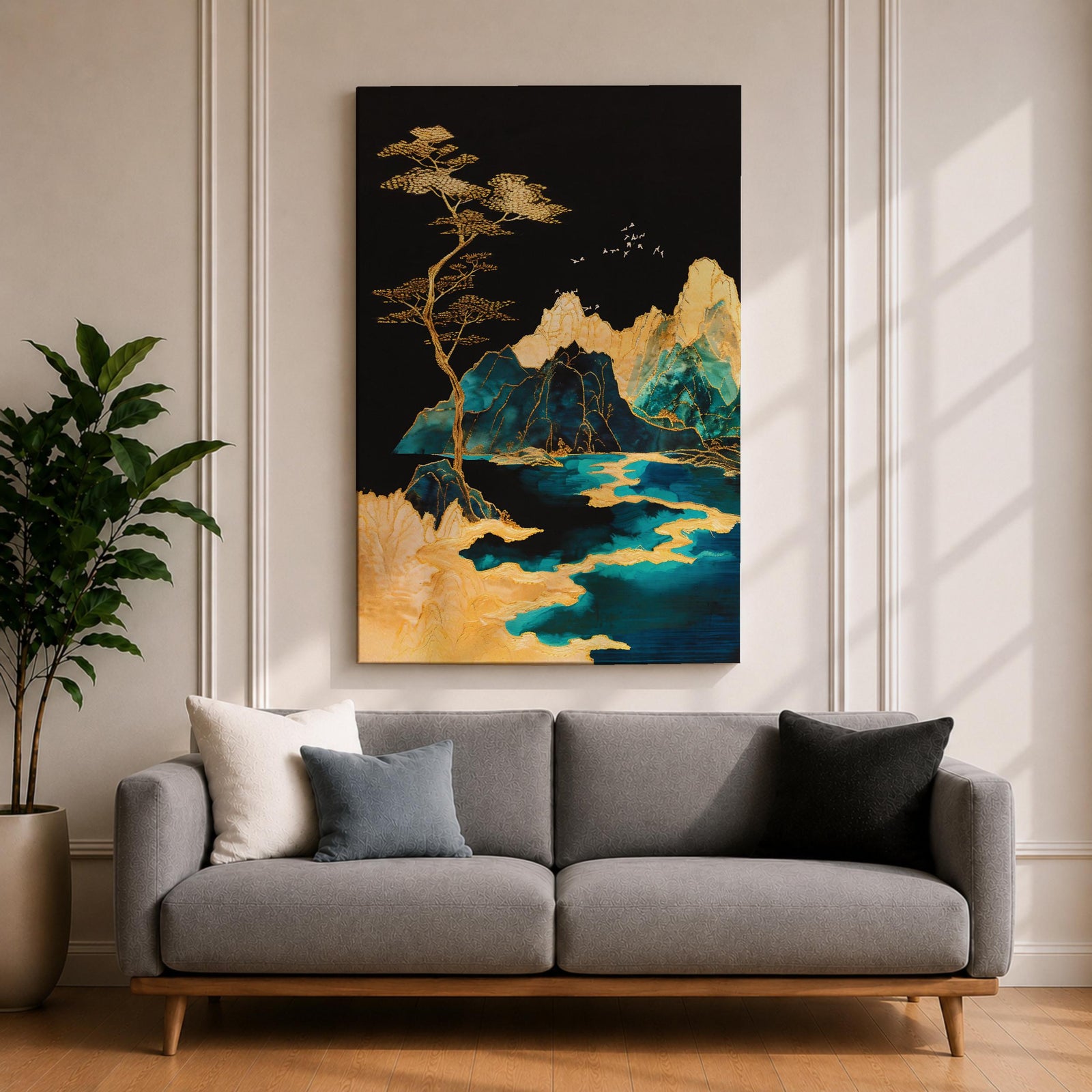 A framed canvas artwork depicting a mountain landscape with abstract golden and teal elements. The composition features stylized mountains, a flowing river, and a tall tree with birds flying above, rendered in an abstract style with rich gold and blue tones against a dark background.