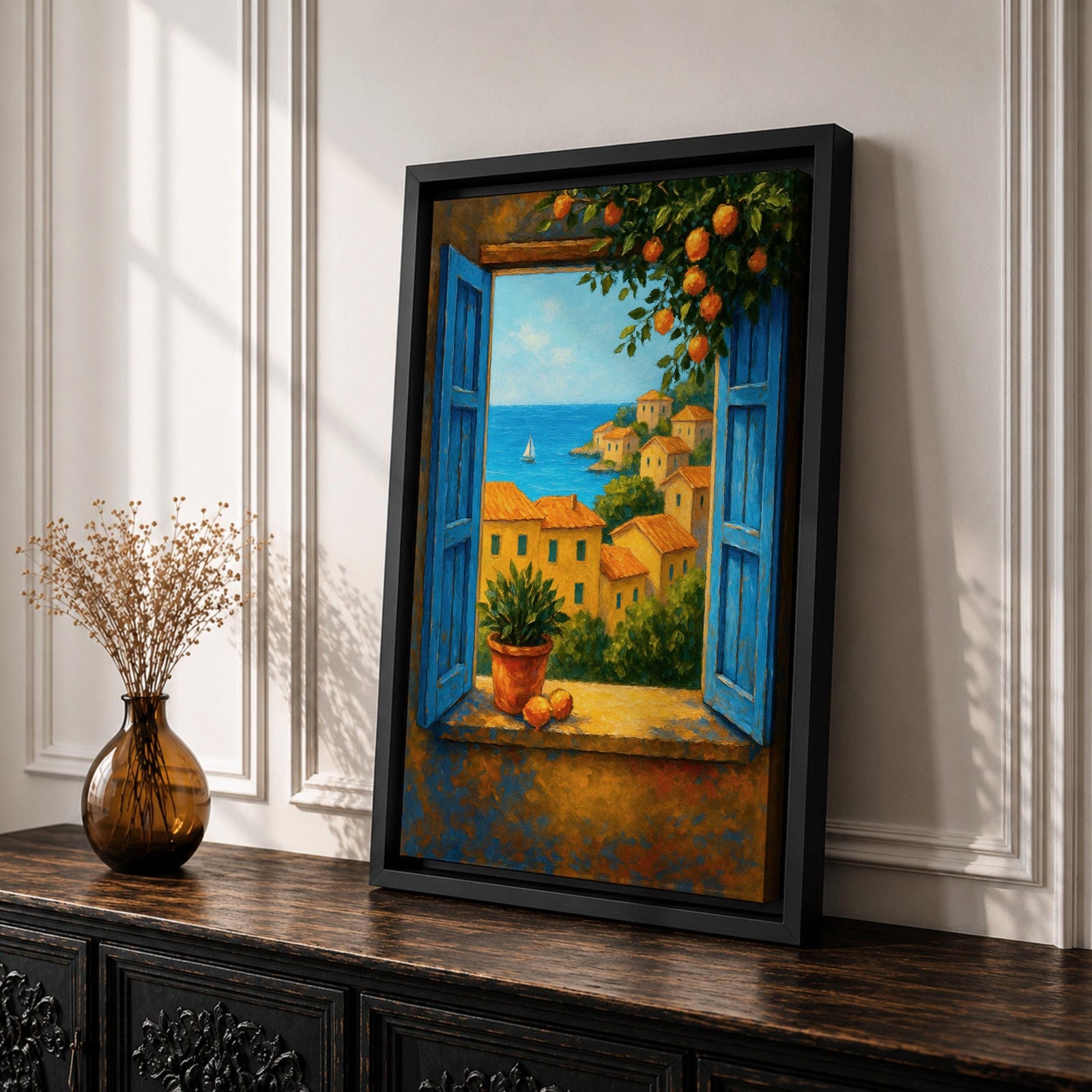 A framed canvas painting depicting a Mediterranean window opening to a seaside coastal view with terracotta-roofed houses, lush greenery, and a distant sailboat on the blue sea, rendered in a realistic landscape style with vibrant colors and detailed brushwork.