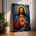 A stained glass style depiction of the Sacred Heart of Jesus shows Jesus with long hair and beard, wearing a red robe and blue cloak. His heart is radiant with light, crowned with a cross and surrounded by thorns. The background features geometric blue and gold stained glass tiles forming a halo.