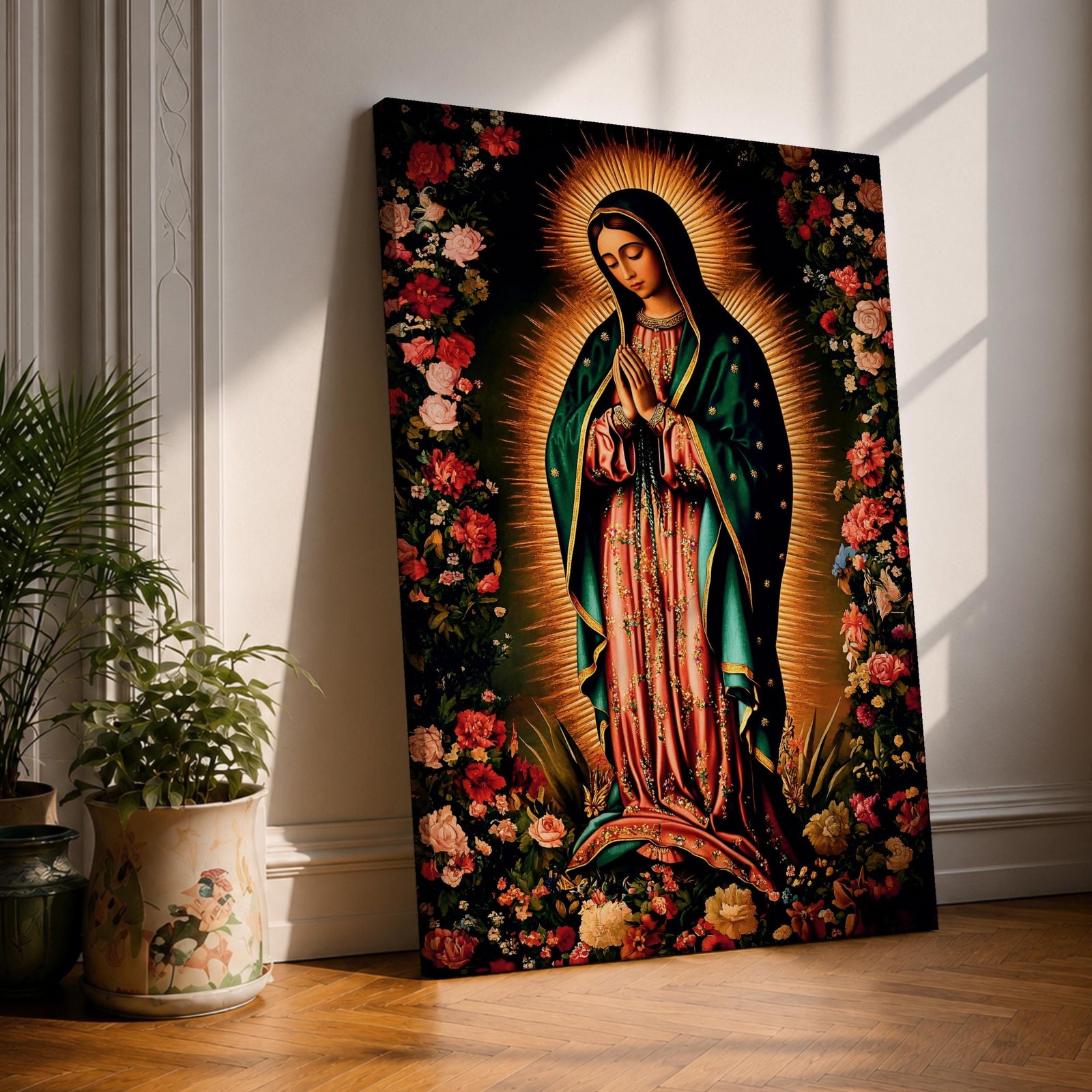 A detailed framed canvas print depicting Our Lady of Guadalupe, showing the Virgin of Guadalupe surrounded by a floral border with radiant light emanating behind her, rendered in a traditional Mexican religious art style with vivid colors and intricate floral patterns.