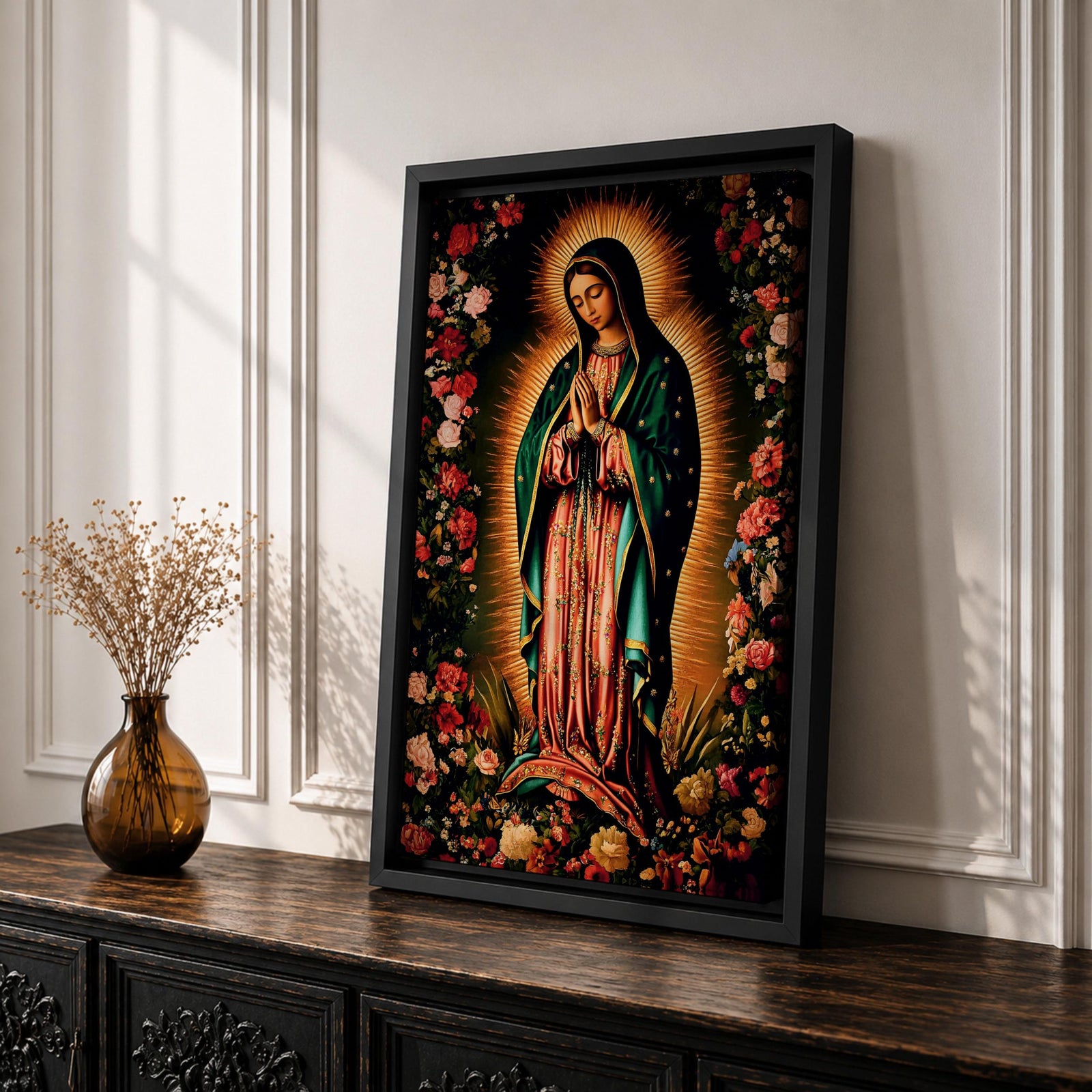 A detailed framed canvas print depicting Our Lady of Guadalupe, showing the Virgin of Guadalupe surrounded by a floral border with radiant light emanating behind her, rendered in a traditional Mexican religious art style with vivid colors and intricate floral patterns.
