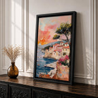 An impasto style painting depicting a Mediterranean village perched on rocky cliffs by the sea. The textured brushstrokes illustrate terracotta-roofed houses, a tall tree, and small boats floating on blue waters under a warm sunset sky, capturing a vibrant coastal landscape scene.