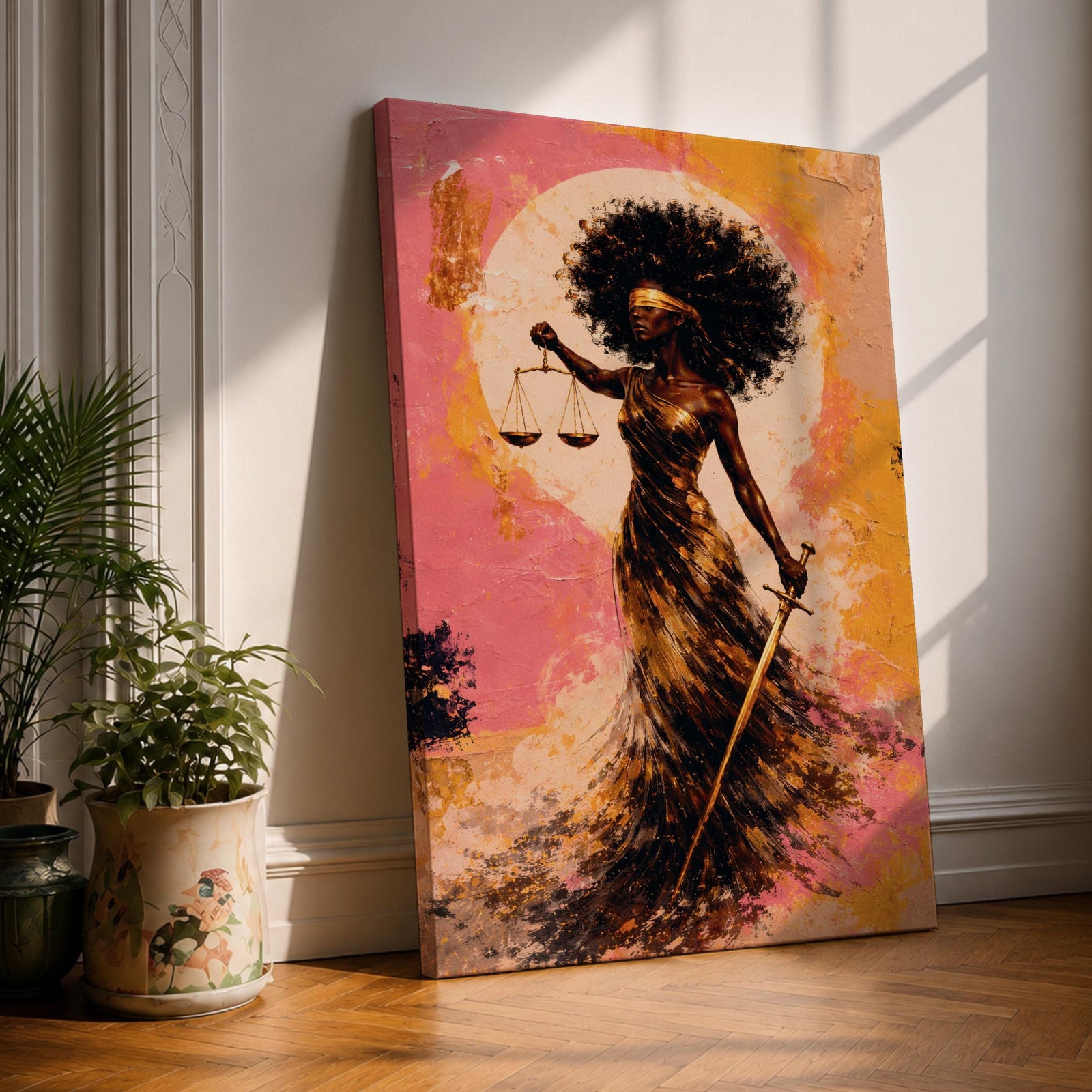 An abstract painting of Lady Justice depicted as a Black woman with a blindfold and voluminous afro, holding balanced scales and a sword, her flowing dress rendered in layered gold and earthy brushstrokes set against a textured pink and warm-toned background with a circular glowing form behind her.