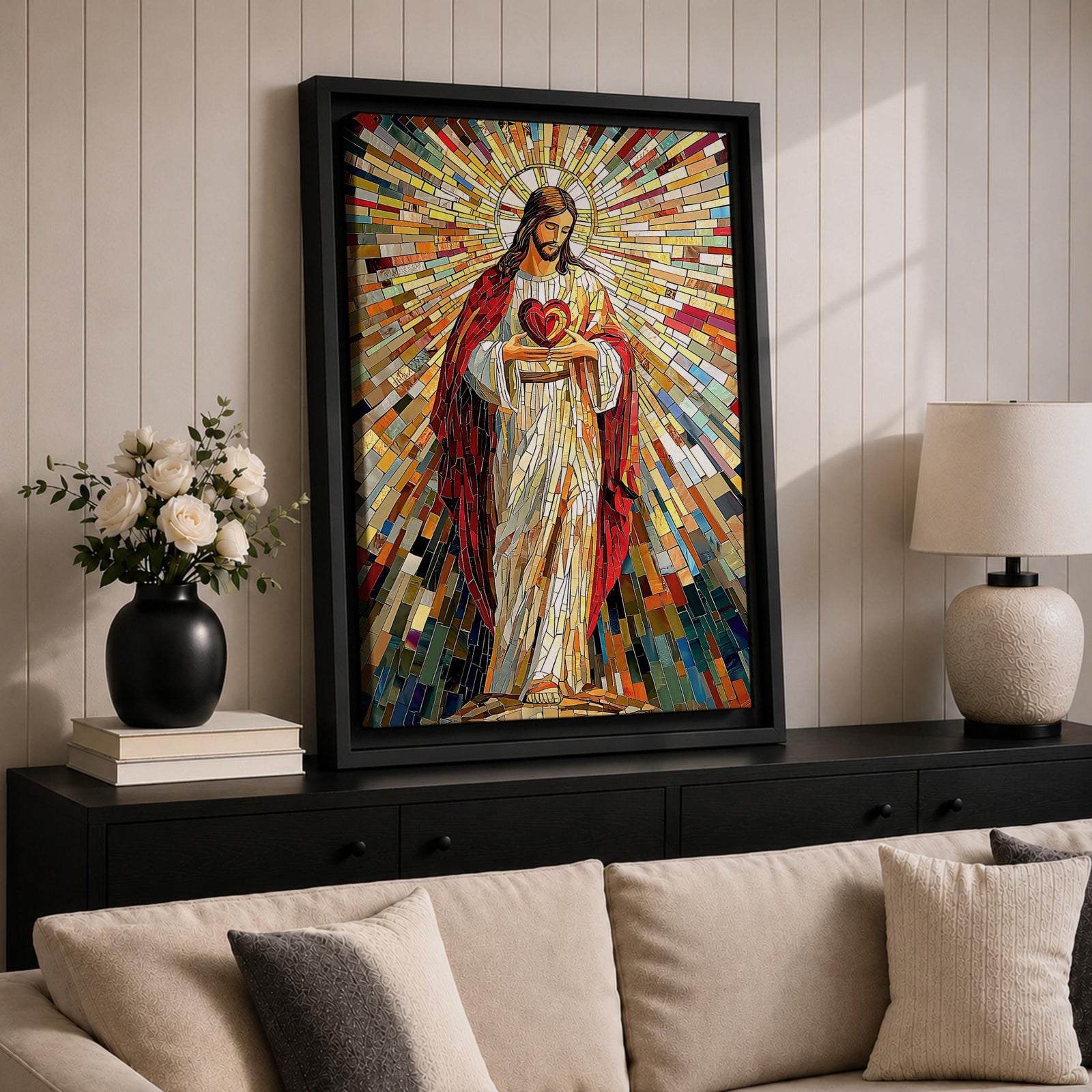 A vibrant mosaic artwork depicting the Sacred Heart of Jesus with radiant geometric stained glass tiles. The figure is shown holding a heart with rays emanating outward, framed in wood, combining traditional religious iconography with a colorful mosaic style.