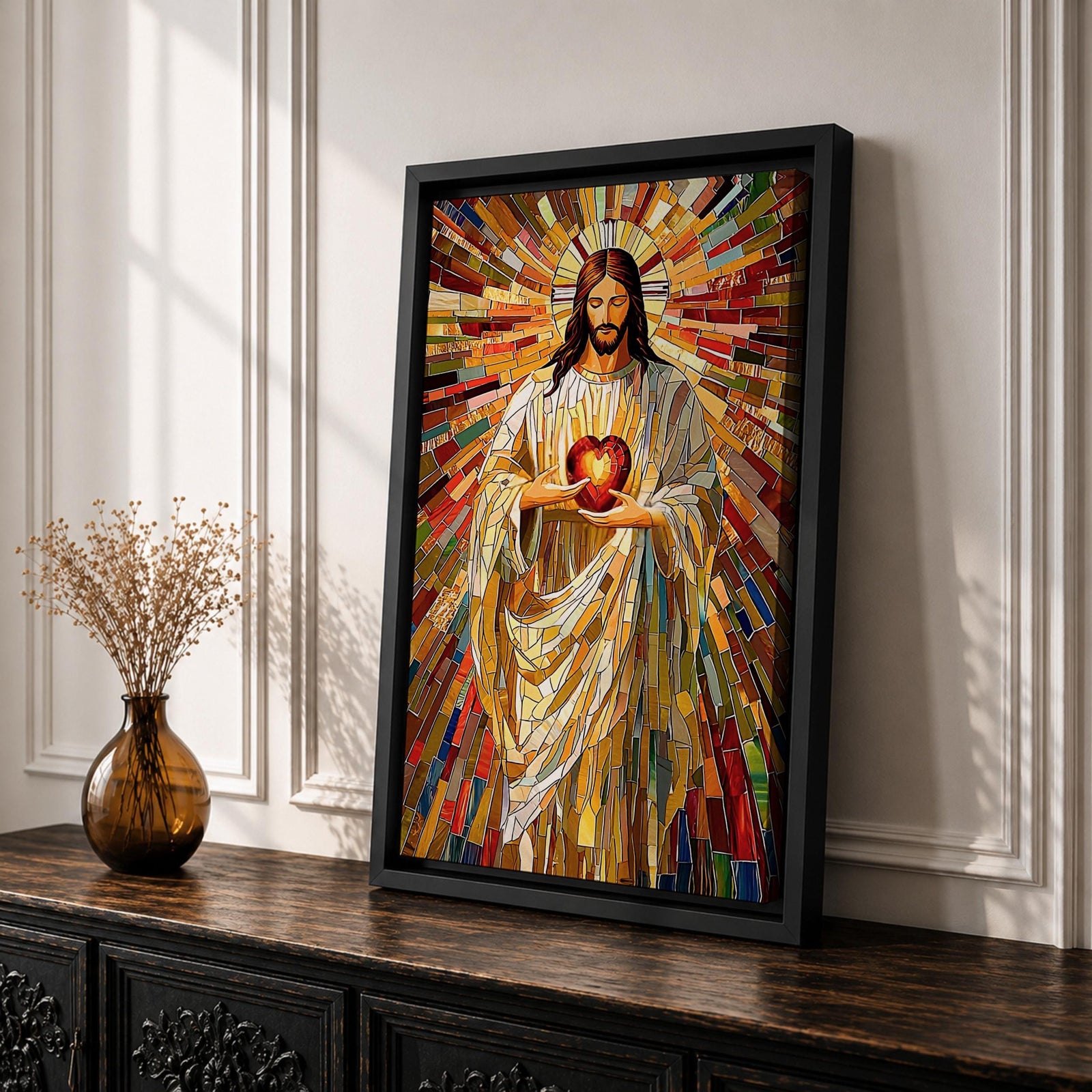 A vibrant mosaic stained glass style artwork depicting the Sacred Heart of Jesus holding a glowing heart. The image features intricate geometric glass fragments in warm tones radiating outward, emphasizing the central figure with flowing robes and a halo behind his head, rendered in a religious mosaic style.