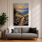 An impasto style framed canvas painting depicting a coastal sunset path bordered by vibrant wildflowers leading to a calm sea with distant mountains under a colorful sky. The textured brush strokes emphasize the natural landscape and seaside atmosphere.