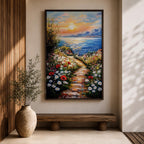 An impasto style framed canvas painting depicting a coastal sunset path bordered by vibrant wildflowers leading to a calm sea with distant mountains under a colorful sky. The textured brush strokes emphasize the natural landscape and seaside atmosphere.