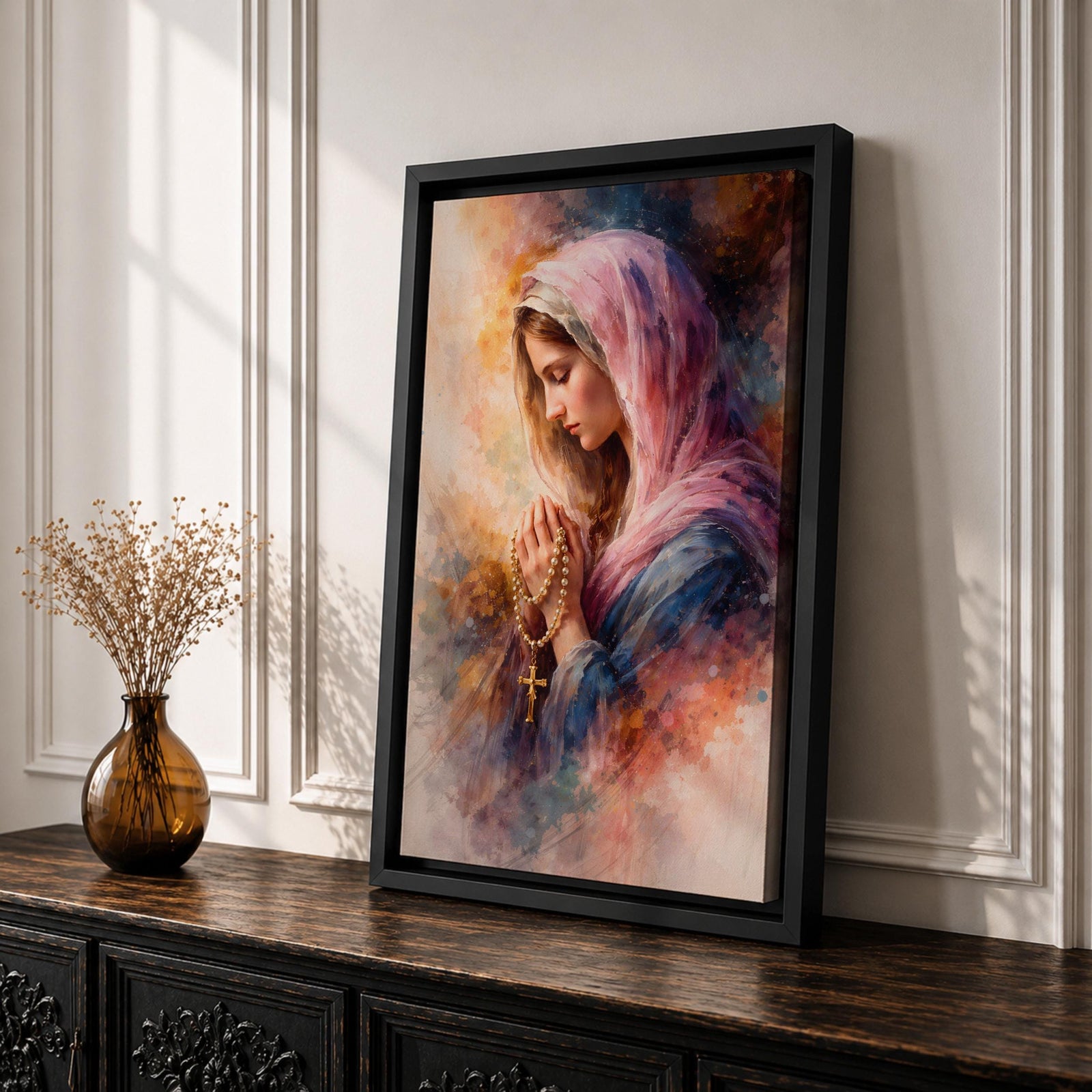 A watercolor style painting of the Virgin Mary wearing a pink hooded shawl, holding a rosary with a gold cross, her eyes closed in prayer, surrounded by soft, blended warm and cool colors creating a serene and contemplative atmosphere.