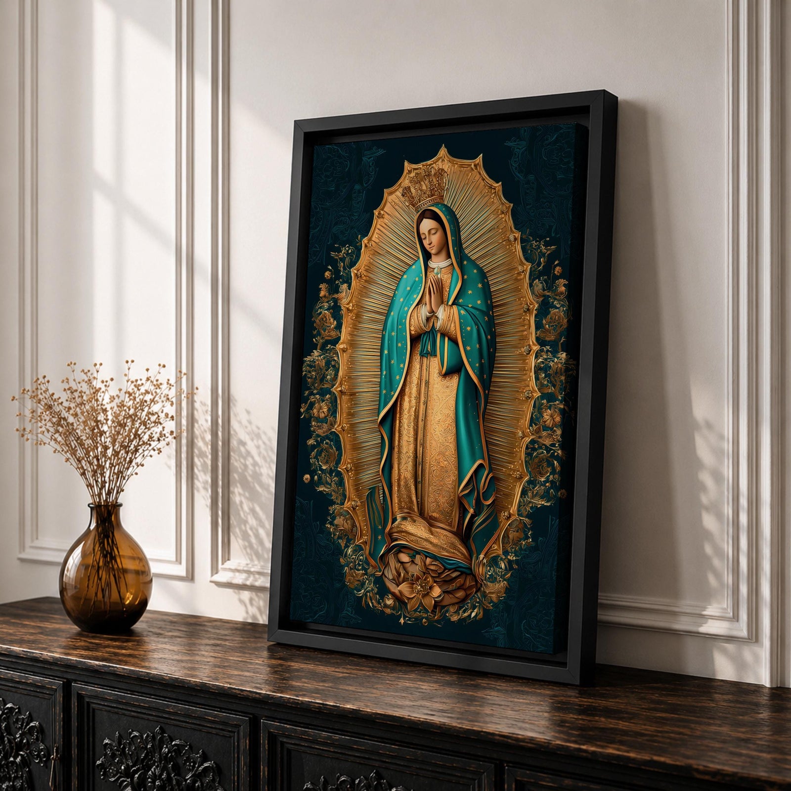A detailed framed canvas artwork depicting Our Lady of Guadalupe standing with hands clasped in prayer, surrounded by a radiant golden aura and floral motifs, rendered in a traditional style emphasizing intricate patterns and symbolic elements.