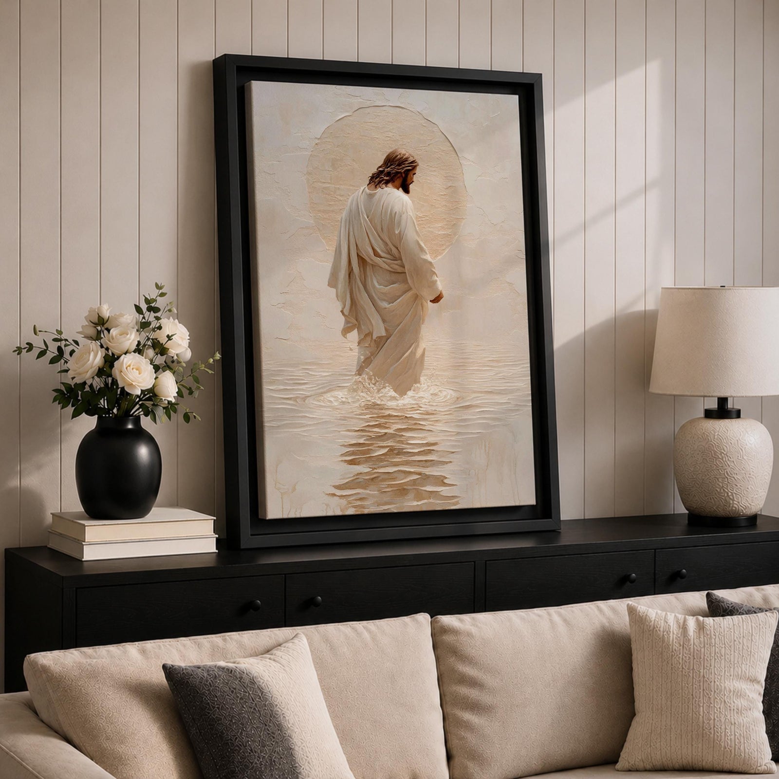 A framed canvas artwork depicting Jesus walking on water, showing him in a flowing robe with rippling water beneath and a glowing halo behind his head. The style is realistic with textured brush strokes emphasizing the water’s movement and the figure’s serene posture.