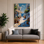 An impasto style painting depicting a charming Greek island village street with whitewashed buildings, colorful flowers in pots, balconies, and a view of the blue sea under a partly cloudy sky. The textured brushstrokes create a vivid Mediterranean coastal atmosphere.