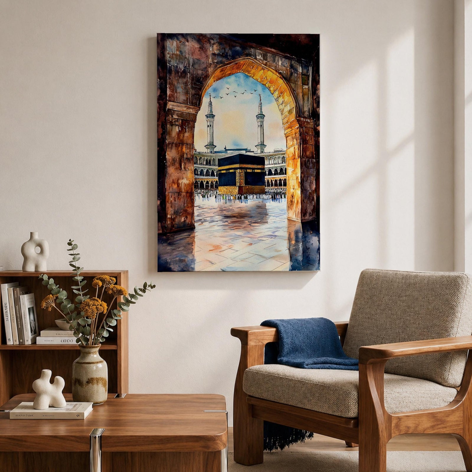 Watercolor-style painting of the Kaaba in Masjid al-Haram viewed through a large stone archway, showing the sacred courtyard with pilgrims and two tall minarets rising above the mosque.