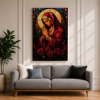 A stained glass style artwork depicting the Virgin Mary in a red robe with hands clasped in prayer, surrounded by a glowing halo and red roses at the bottom. The piece features intricate glass-like segments and rich colors, capturing a classic religious stained glass window aesthetic.