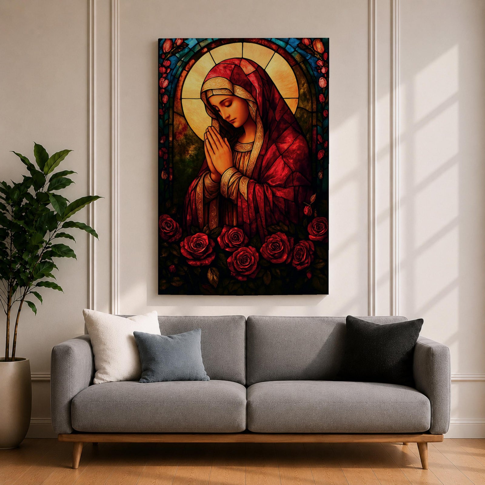 A stained glass style artwork depicting the Virgin Mary in a red robe with hands clasped in prayer, surrounded by a glowing halo and red roses at the bottom. The piece features intricate glass-like segments and rich colors, capturing a classic religious stained glass window aesthetic.