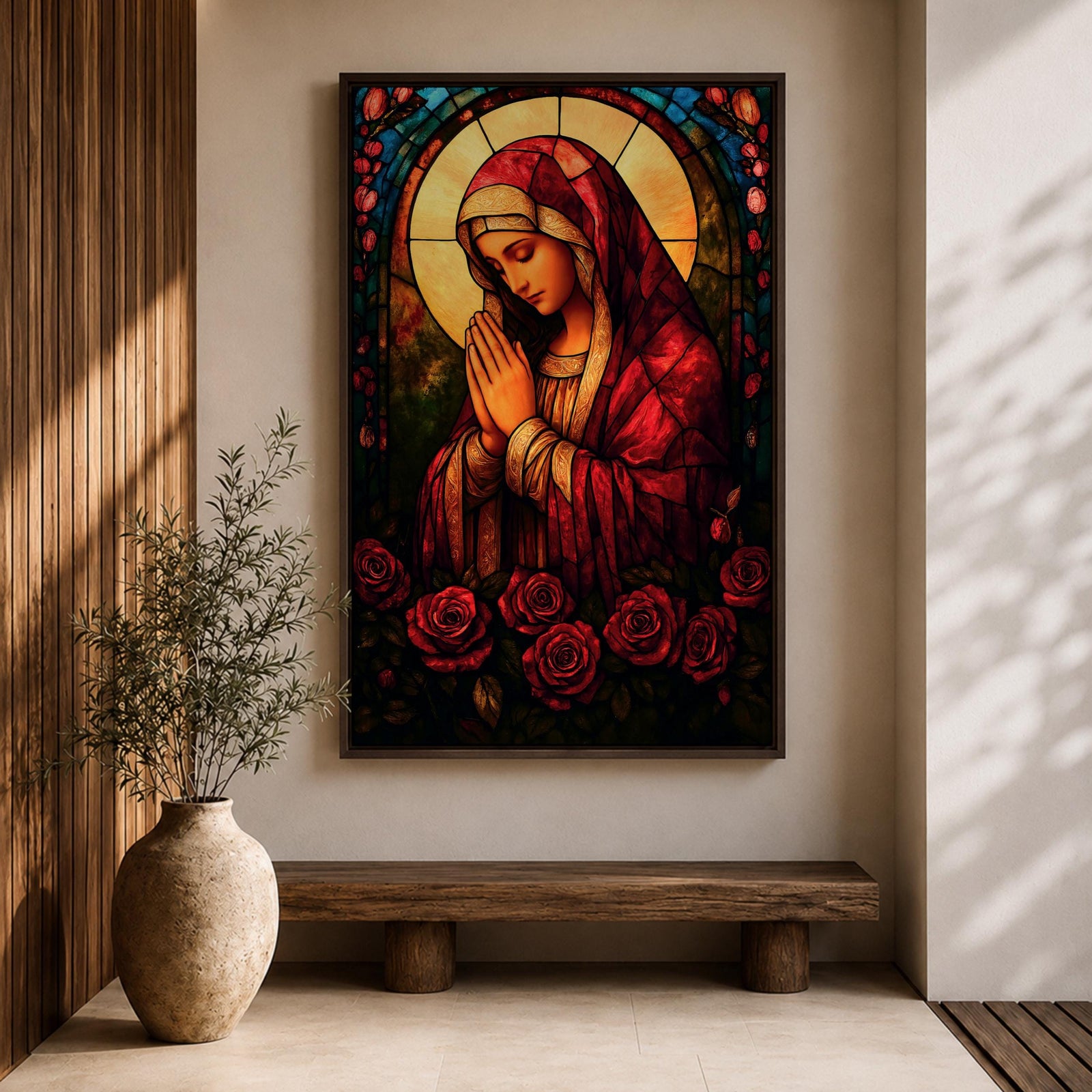A stained glass style artwork depicting the Virgin Mary in a red robe with hands clasped in prayer, surrounded by a glowing halo and red roses at the bottom. The piece features intricate glass-like segments and rich colors, capturing a classic religious stained glass window aesthetic.