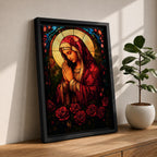A stained glass style artwork depicting the Virgin Mary in a red robe with hands clasped in prayer, surrounded by a glowing halo and red roses at the bottom. The piece features intricate glass-like segments and rich colors, capturing a classic religious stained glass window aesthetic.