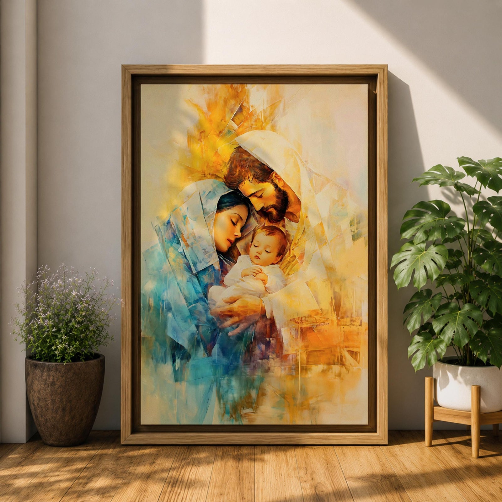 A framed canvas artwork depicting the Holy Family with Mary, Joseph, and baby Jesus in a tender embrace. The painting features warm tones and soft brush strokes, capturing the intimate moment of the Nativity scene with a focus on the figures' expressions and clothing details.
