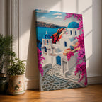 A vibrant framed canvas depicting Santorini, Greece, featuring iconic white buildings with blue domes, winding cobblestone paths, and bright bougainvillea flowers overlooking a deep blue sea, rendered in a clean, graphic style emphasizing architectural shapes and Mediterranean coastal charm.