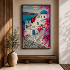 A vibrant framed canvas depicting Santorini, Greece, featuring iconic white buildings with blue domes, winding cobblestone paths, and bright bougainvillea flowers overlooking a deep blue sea, rendered in a clean, graphic style emphasizing architectural shapes and Mediterranean coastal charm.