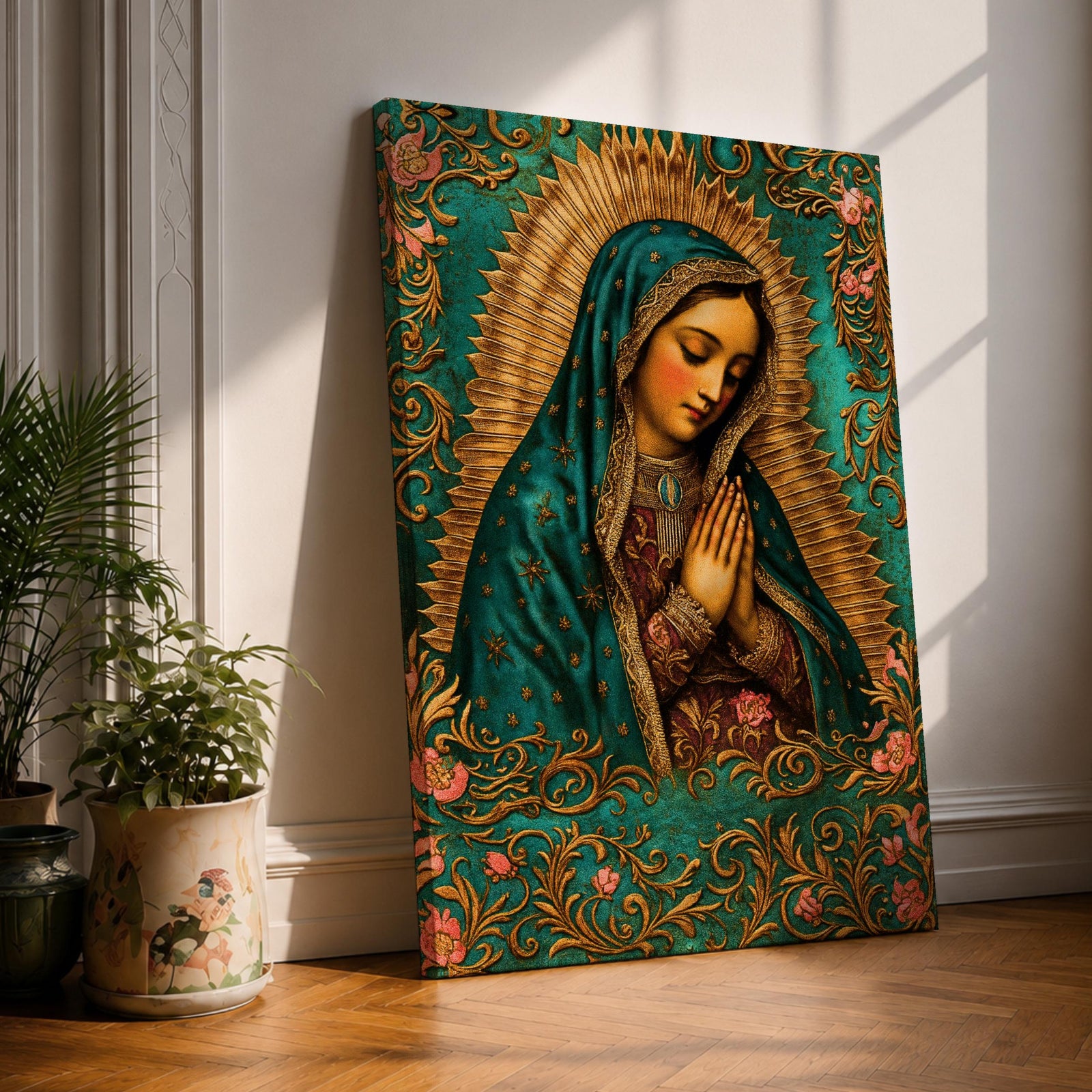 A vintage-style framed canvas depicting Our Lady of Guadalupe with her hands clasped in prayer, wearing a teal mantle adorned with stars and a golden halo radiating behind her. The artwork features intricate floral patterns surrounding the figure, emphasizing traditional Mexican Catholic iconography.