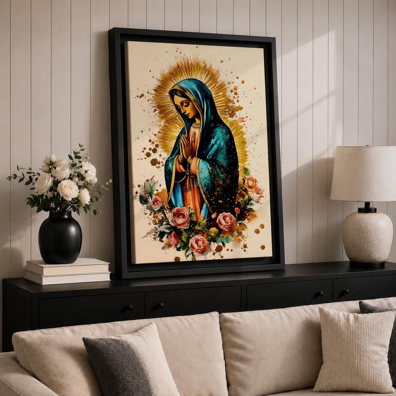 A detailed framed canvas print depicting Our Lady of Guadalupe with hands clasped in prayer, wearing a blue mantle and surrounded by a golden aura and pink roses, rendered in a vibrant, illustrative style emphasizing cultural and religious symbolism.