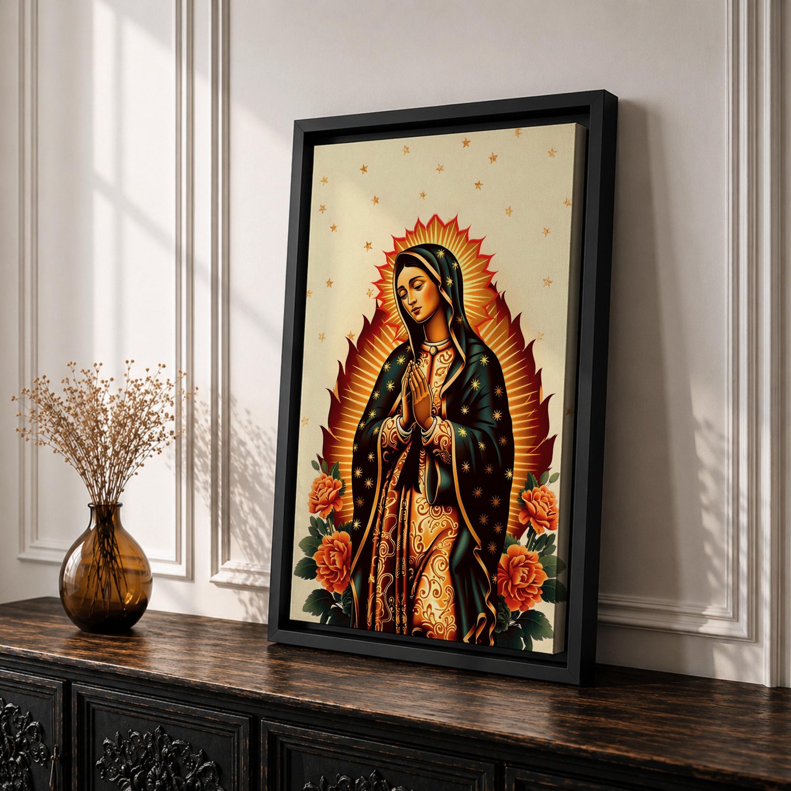 A devotional depiction of Our Lady of Guadalupe standing with hands folded in prayer, wearing a rose pink gown and a teal mantle filled with gold stars, surrounded by radiant golden rays and positioned above a crescent moon with an angel beneath, framed by colorful floral elements in a Mexican Catholic devotional style.
