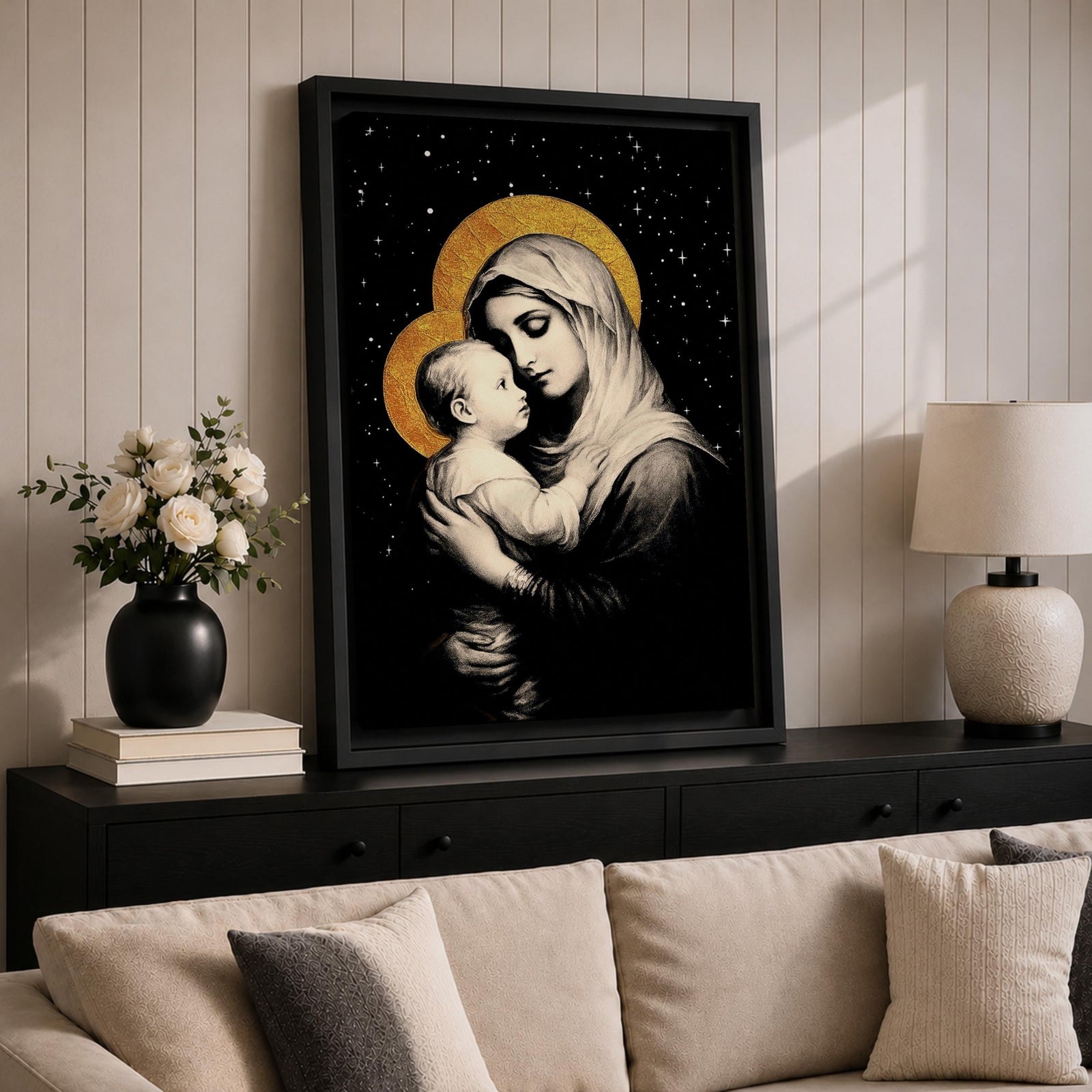 A framed canvas artwork depicting Madonna and Child with golden halos against a starry black background. The image shows the Virgin Mary tenderly holding the infant Jesus, rendered in a classical style with detailed shading and a serene expression, emphasizing their close bond.