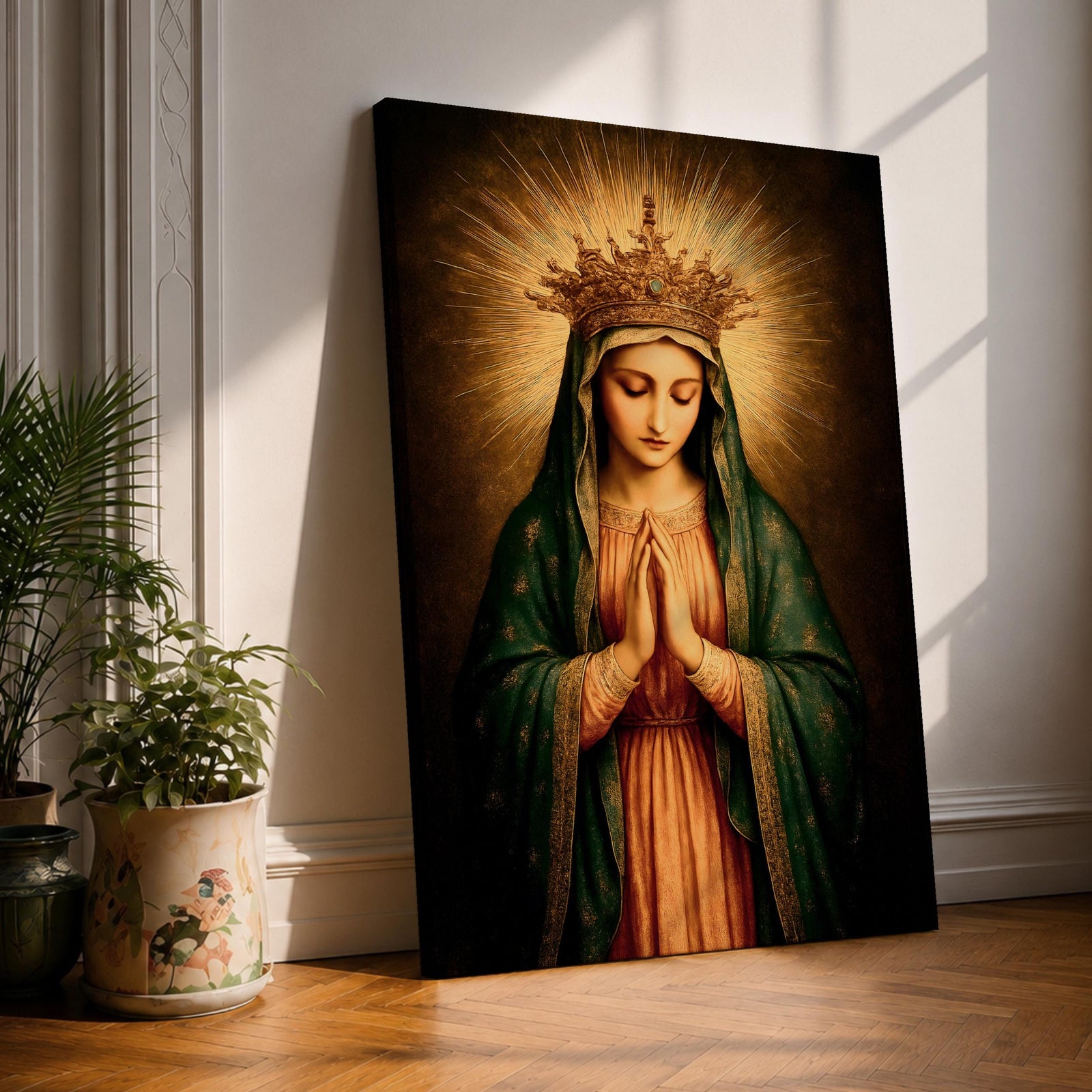 A vintage-style framed canvas wall art depicting the Virgin Mary with a golden crown and radiant halo, hands clasped in prayer, wearing a green cloak over a pink robe, rendered in a classical religious portrait style with warm, glowing tones.