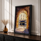 Watercolor-style artwork of the Kaaba at Masjid Al Haram in Mecca viewed through a grand mosque archway with open golden doors and pilgrims gathered in the courtyard beneath tall minarets.