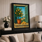 A vibrant framed canvas painting depicting a lemon tree in a terracotta pot set within an open window with blue shutters overlooking a Mediterranean coastal landscape. The artwork captures lush green leaves and ripe lemons with a rustic garden feel, emphasizing natural beauty and outdoor tranquility.