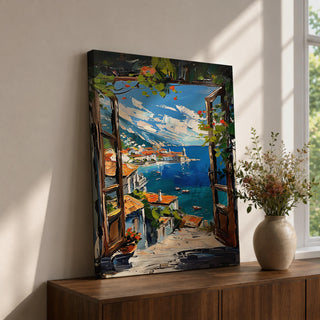A vibrant framed canvas painting depicting a Mediterranean window opening to a coastal seaside view with terracotta rooftops, boats on deep blue ocean waters, and distant mountains under a bright sky. The artwork captures a scenic landscape with detailed brushstrokes and rich textures.