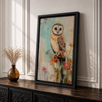 A detailed vintage-style framed canvas art print depicting a barn owl perched on a branch surrounded by wildflowers. The artwork features a rustic, naturalistic approach with soft textures and muted colors, capturing the essence of wildlife and farmhouse charm in a classic animal portrait style.