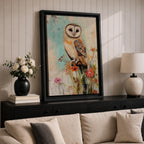 A detailed vintage-style framed canvas art print depicting a barn owl perched on a branch surrounded by wildflowers. The artwork features a rustic, naturalistic approach with soft textures and muted colors, capturing the essence of wildlife and farmhouse charm in a classic animal portrait style.