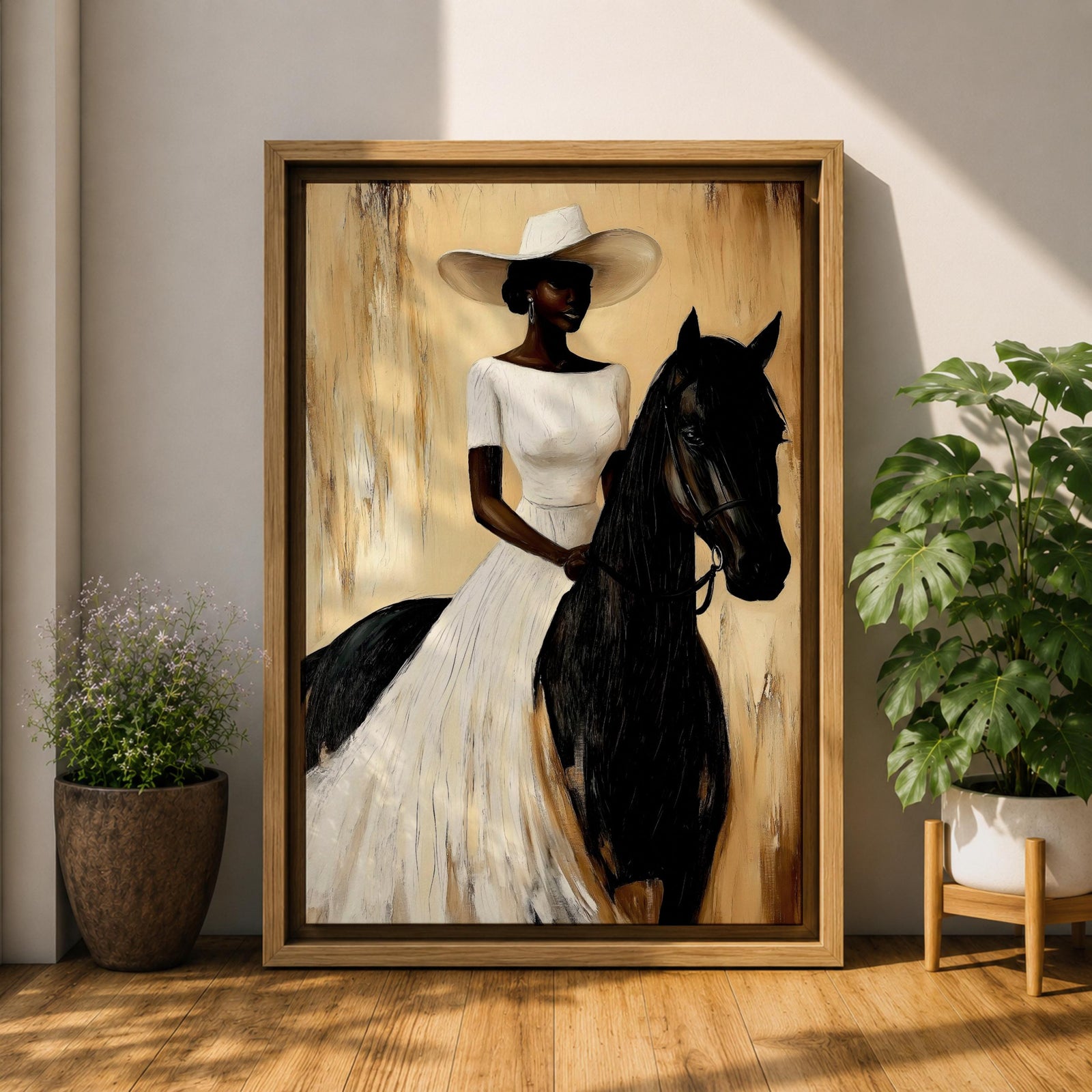 A framed painting of a woman dressed in a white dress and wide-brimmed hat riding a black horse. The artwork features a realistic style with warm beige and brown tones in the background, emphasizing the elegant posture of the rider and the horse’s strong presence.