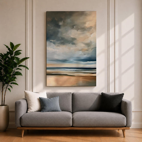 A framed canvas painting depicting a coastal seascape with a cloudy sky over a calm ocean and sandy beach. The artwork features a vintage style with soft brush strokes and muted tones, capturing the serene and expansive nature of the shoreline and sky.
