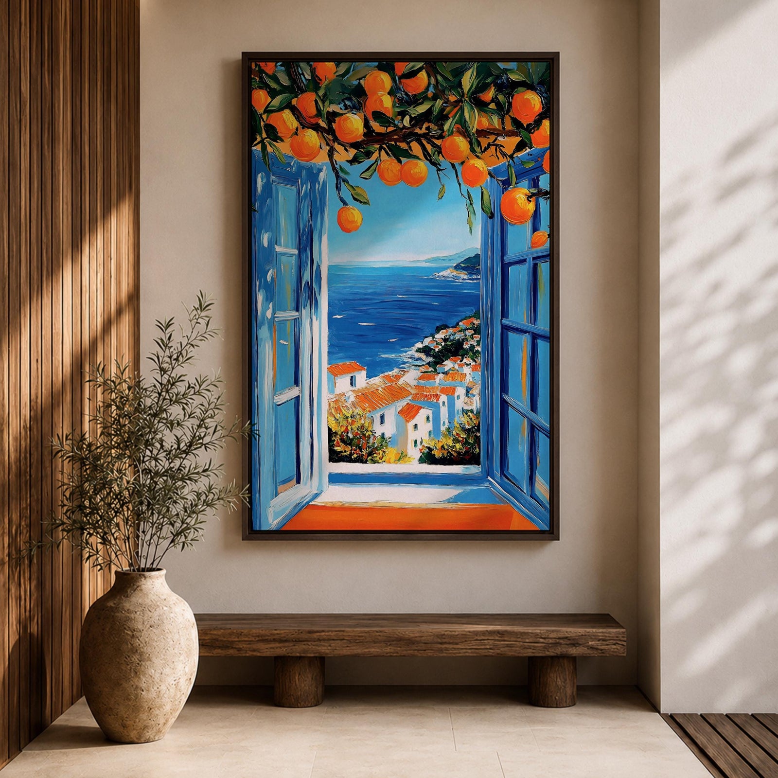 A vibrant framed canvas painting depicting an open Mediterranean-style window with blue shutters overlooking a coastal landscape. Above the window, ripe orange fruits hang from branches, framing a scenic view of white houses with terracotta roofs and a deep blue sea under a clear sky, rendered in a vivid, realistic style.