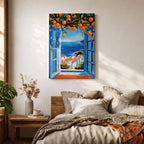 A vibrant framed canvas painting depicting an open Mediterranean-style window with blue shutters overlooking a coastal landscape. Above the window, ripe orange fruits hang from branches, framing a scenic view of white houses with terracotta roofs and a deep blue sea under a clear sky, rendered in a vivid, realistic style.