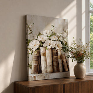 A framed canvas painting depicting a bookshelf with vintage-style books and white peony flowers arranged among the spines, rendered in a textured impasto technique with soft, natural tones and a cottagecore aesthetic.