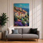 This impasto style painting depicts a vibrant Mediterranean village with terracotta-roofed houses clustered on a hillside surrounded by lush greenery and colorful flowers, set against a bright blue sky and distant mountains, capturing the charm and warmth of a coastal landscape.