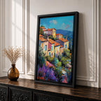 This impasto style painting depicts a vibrant Mediterranean village with terracotta-roofed houses clustered on a hillside surrounded by lush greenery and colorful flowers, set against a bright blue sky and distant mountains, capturing the charm and warmth of a coastal landscape.