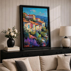 This impasto style painting depicts a vibrant Mediterranean village with terracotta-roofed houses clustered on a hillside surrounded by lush greenery and colorful flowers, set against a bright blue sky and distant mountains, capturing the charm and warmth of a coastal landscape.