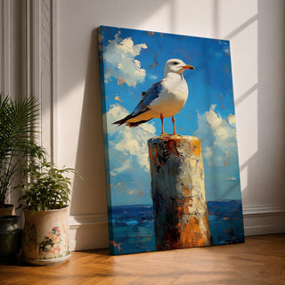 A framed canvas painting of a seagull perched on a weathered post against a bright blue sky with fluffy clouds and a distant ocean horizon. The artwork captures the bird in a realistic style with textured brushstrokes emphasizing the natural coastal scene.
