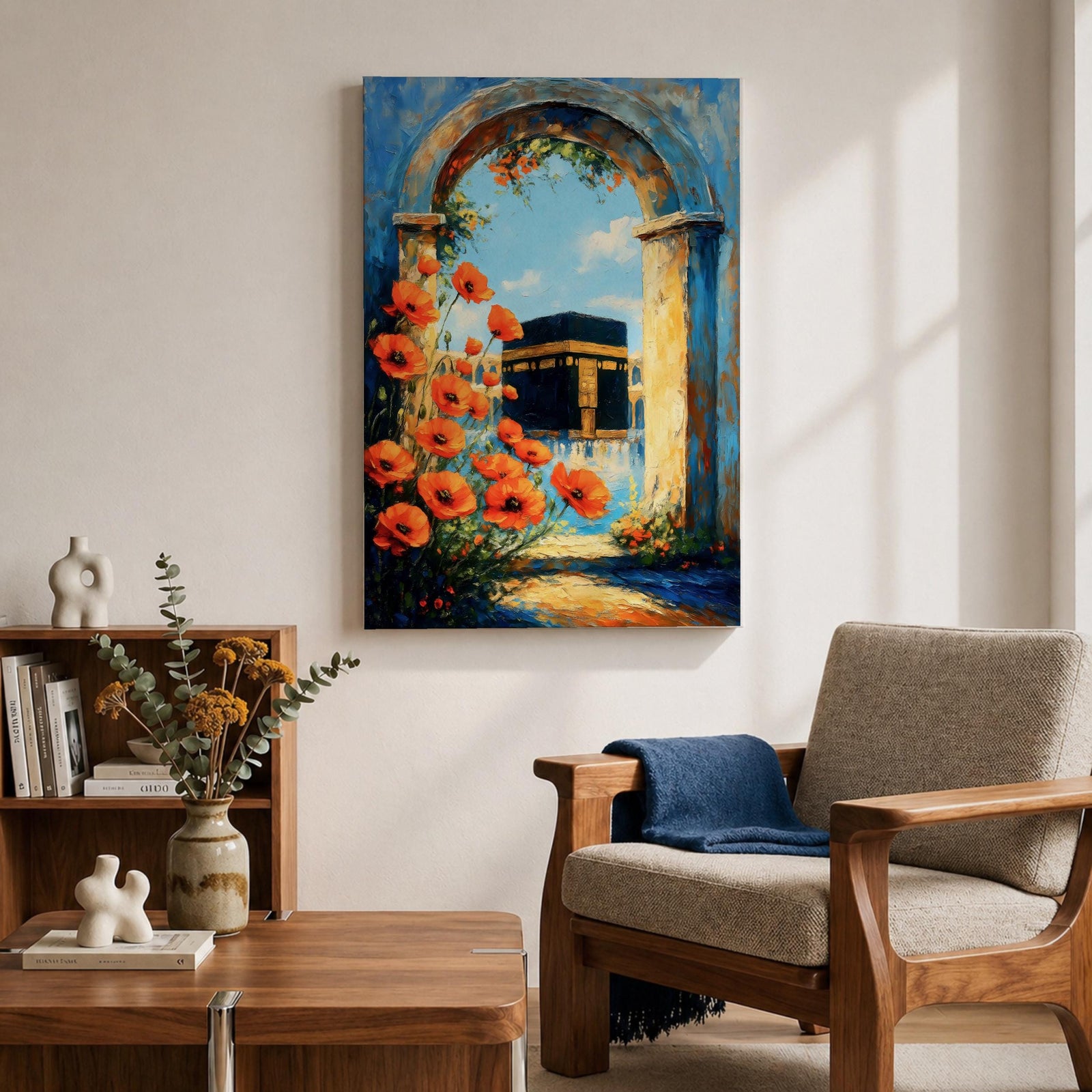 A vibrant painting depicting the Kaaba framed by an ancient stone arch adorned with bright orange flowers. The artwork captures the iconic Islamic holy site with a clear blue sky background, rendered in a realistic style emphasizing architectural and floral details.