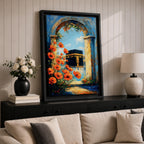 A vibrant painting depicting the Kaaba framed by an ancient stone arch adorned with bright orange flowers. The artwork captures the iconic Islamic holy site with a clear blue sky background, rendered in a realistic style emphasizing architectural and floral details.