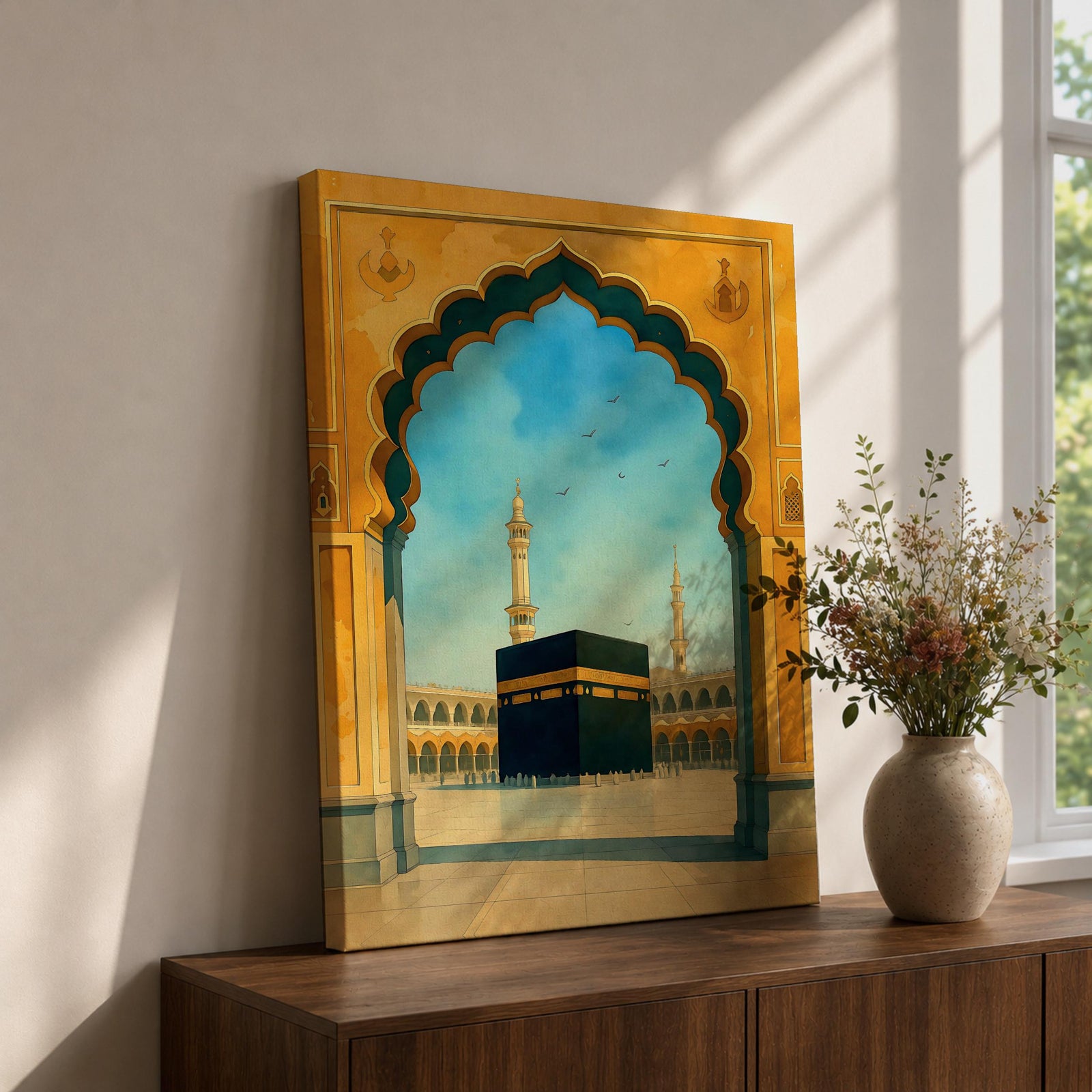 A watercolor style framed canvas wall art depicting the Kaaba viewed through an ornate Islamic arch with minarets and birds in the background. The artwork captures the iconic religious site in Mecca with detailed architectural elements and a serene sky, emphasizing Islamic cultural heritage.
