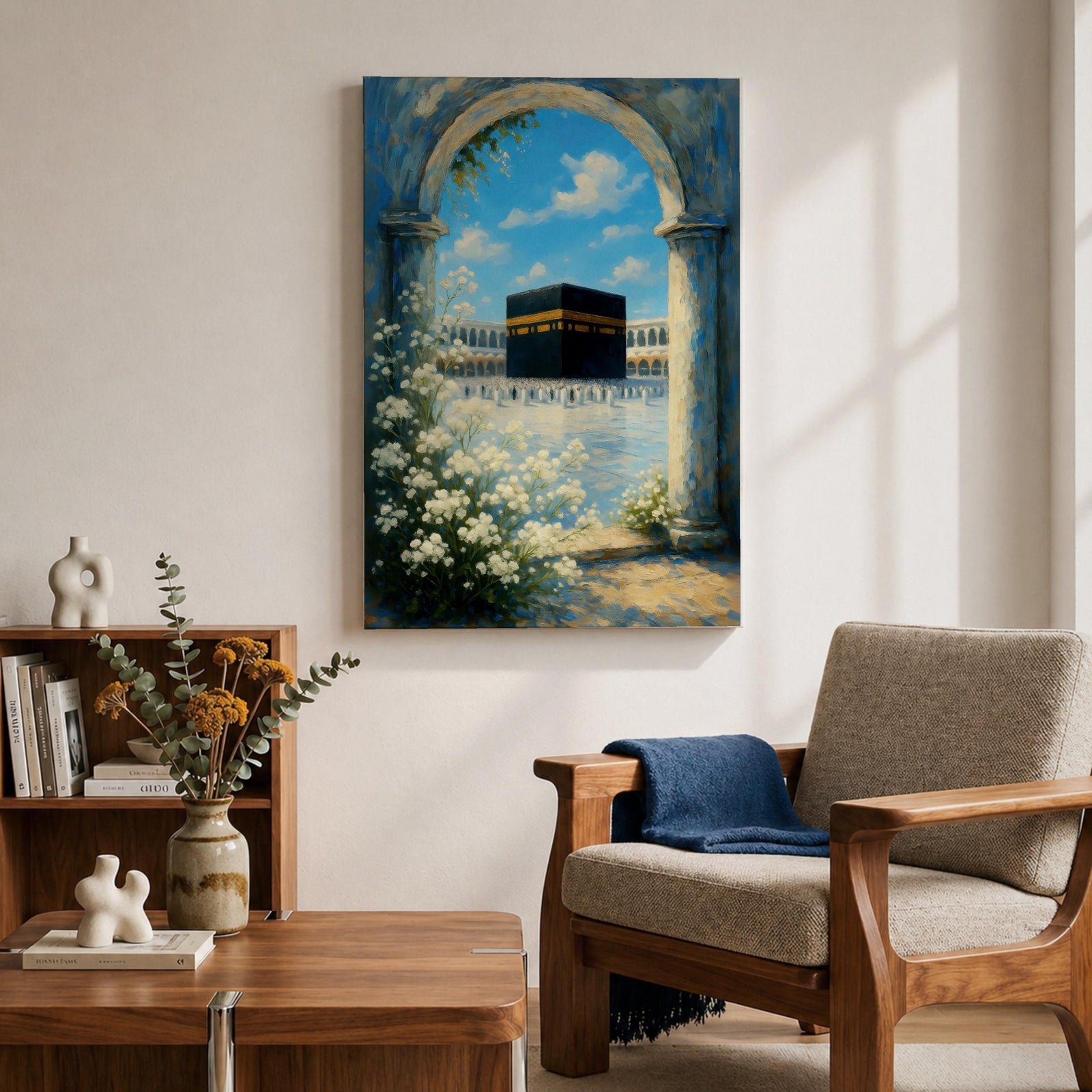 A watercolor painting depicting the Kaaba framed by a floral arch with white blossoms and stone columns, set against a bright blue sky with soft clouds, capturing the iconic Islamic holy site in Mecca with delicate brushwork and vibrant colors.