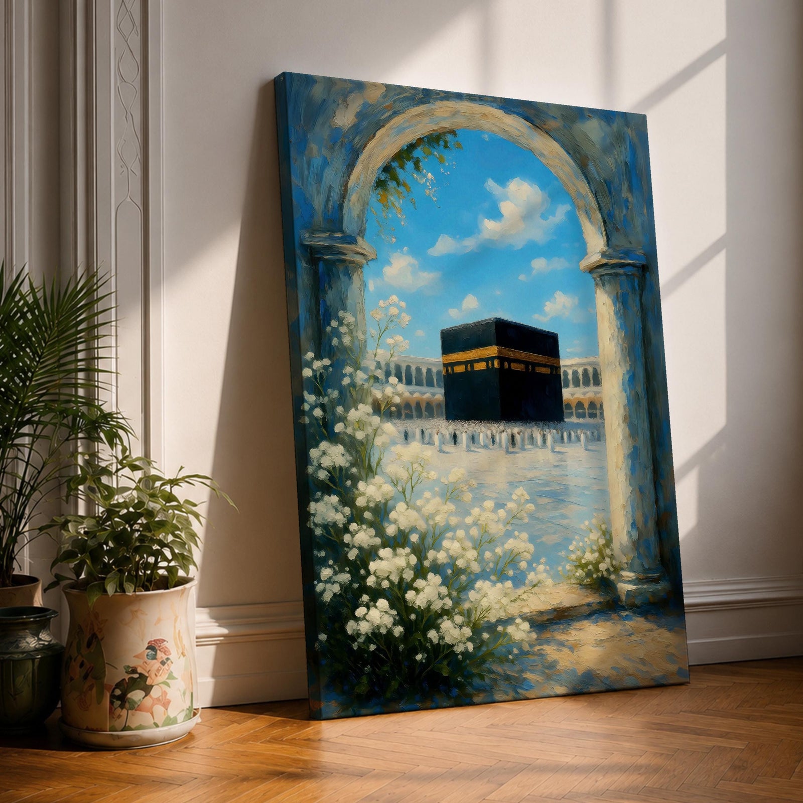 A watercolor painting depicting the Kaaba framed by a floral arch with white blossoms and stone columns, set against a bright blue sky with soft clouds, capturing the iconic Islamic holy site in Mecca with delicate brushwork and vibrant colors.