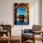 A vibrant framed canvas artwork depicting the Kaaba viewed through a golden arched doorway at Masjid Al Haram in Mecca. The scene shows the iconic black cube structure with gold detailing, two minarets in the background, and a reflective tiled floor under a bright blue sky with birds flying.