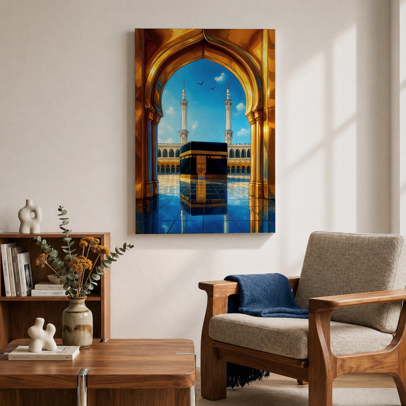 A vibrant framed canvas artwork depicting the Kaaba viewed through a golden arched doorway at Masjid Al Haram in Mecca. The scene shows the iconic black cube structure with gold detailing, two minarets in the background, and a reflective tiled floor under a bright blue sky with birds flying.